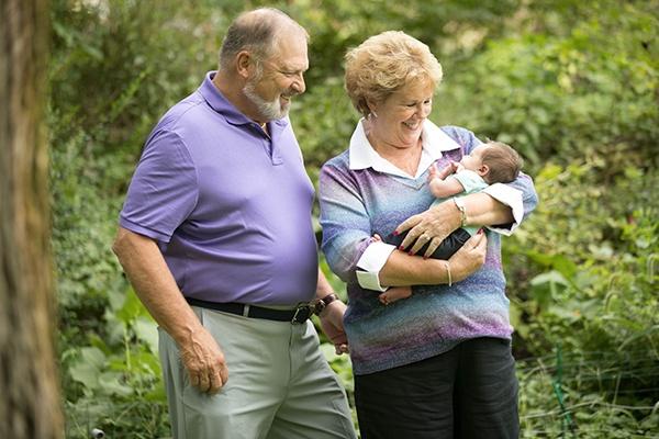 Couple holding grandchild